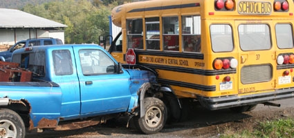 Truck hits school bus while avoiding dump truck