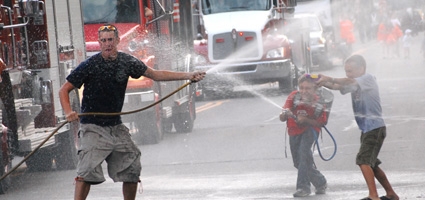 Firefighters hose around on parade route