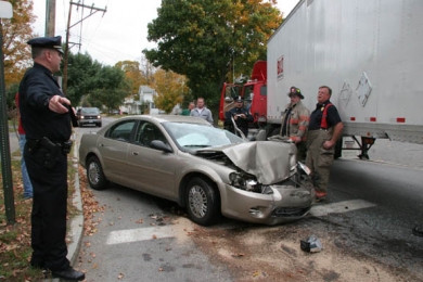 Car, tractor-trailer collide at city  intersection