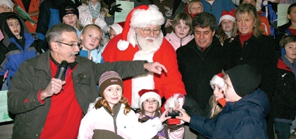 Santa helps kids light downtown trees