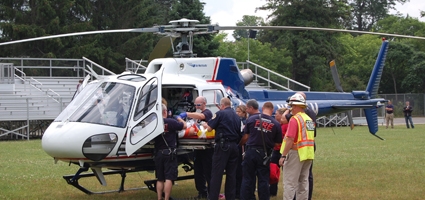 One airlifted after falling from roof